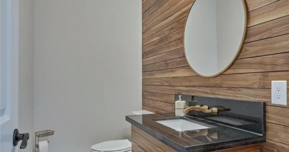 Stylish powder bathroom featuring modern fixtures and tile work